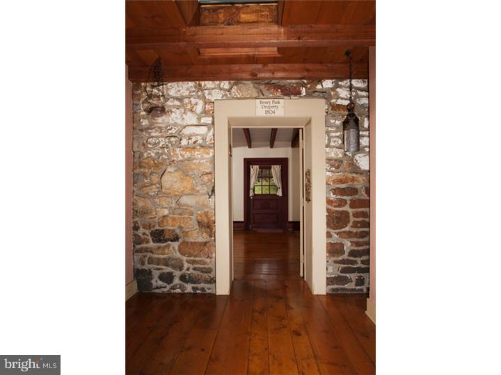 3050 Cooks Creek Road Riegelsville, PA 18077 - Photo 6 of 25 a view of a hallway with wooden floor and a fireplace