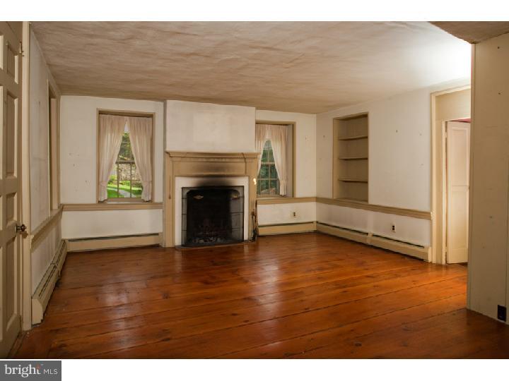 3050 Cooks Creek Road Riegelsville, PA 18077 - Photo 9 of 25 a view of a livingroom with wooden floor and a fireplace