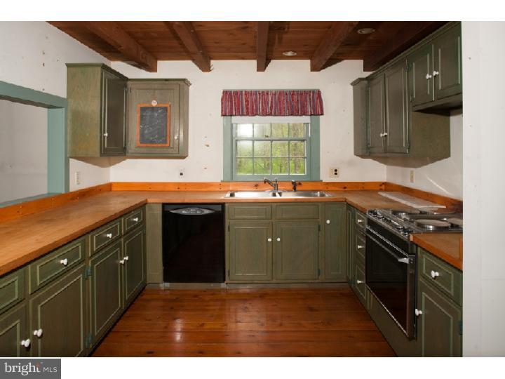 3050 Cooks Creek Road Riegelsville, PA 18077 - Photo 10 of 25 a kitchen with stainless steel appliances granite countertop a sink stove and cabinets