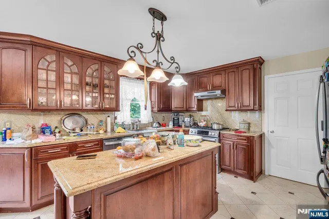 a kitchen with a sink a stove and cabinets