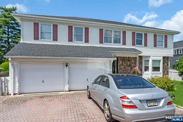 a front view of a house with parking area