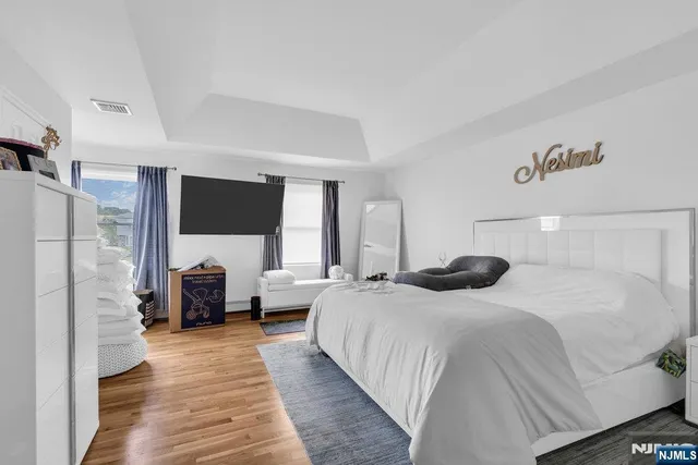 a bedroom with a large bed couch and a window