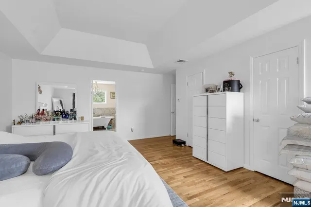 a bedroom with a bed and a view of bedroom