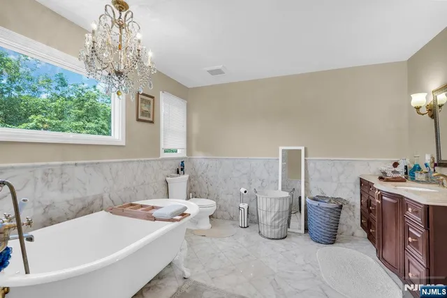 a bathroom with a tub sink and window