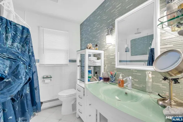 a bathroom with a sink toilet tub and shower