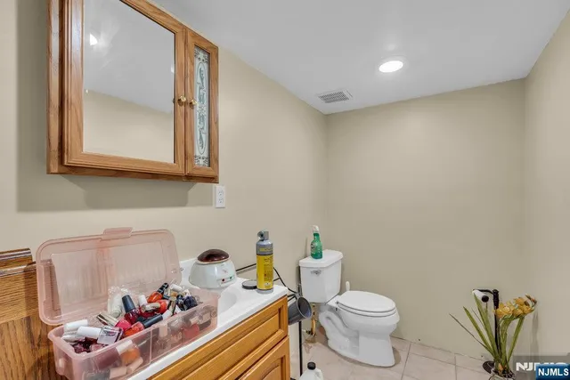 a bathroom with a toilet a sink and a mirror