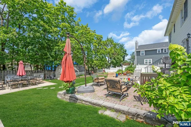 a view of a backyard with a table and chairs