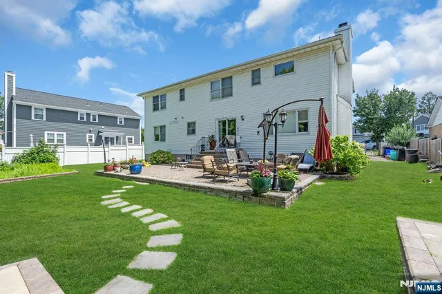 a view of a house with backyard and sitting area