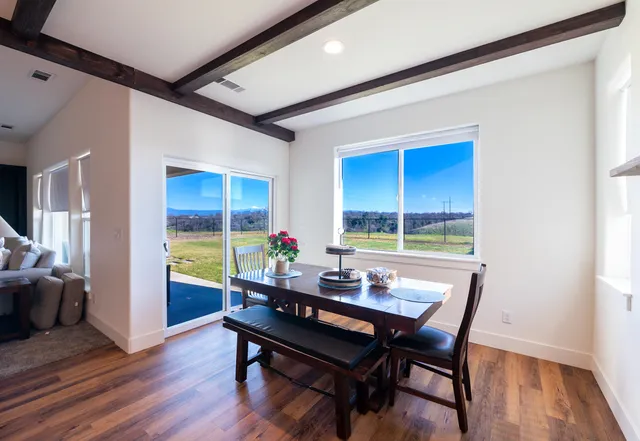 a view of a dining room with furniture and window