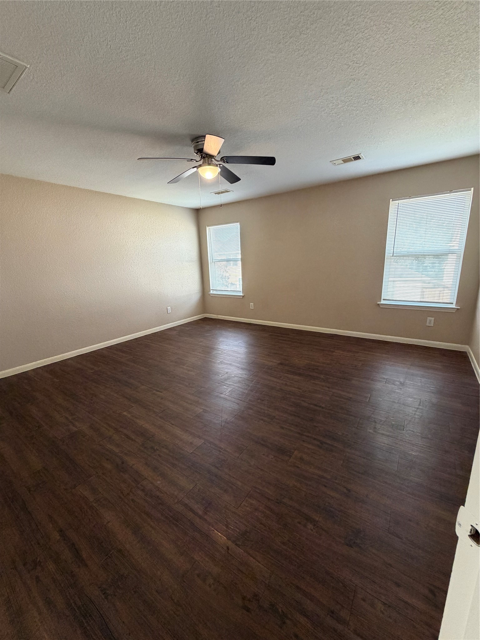 13230 Montclair Point Court Houston, TX 77047 - Photo 2 of 16 an empty room with wooden floor chandelier fan and windows