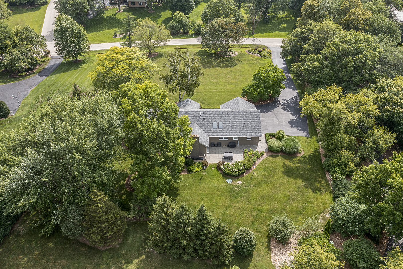 1500 Appleby Road Inverness, IL 60067 - Photo 27 of 27 an aerial view of a house with a yard lake and trees all around