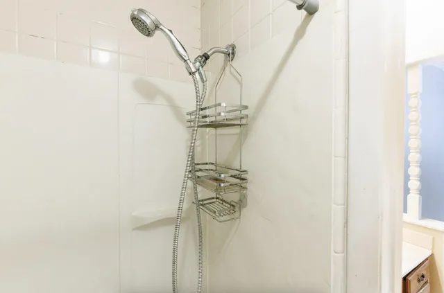 a bathroom with a granite countertop sink and a large mirror