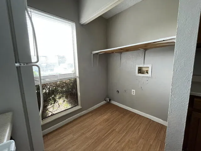a bathroom with a granite countertop toilet and a tub
