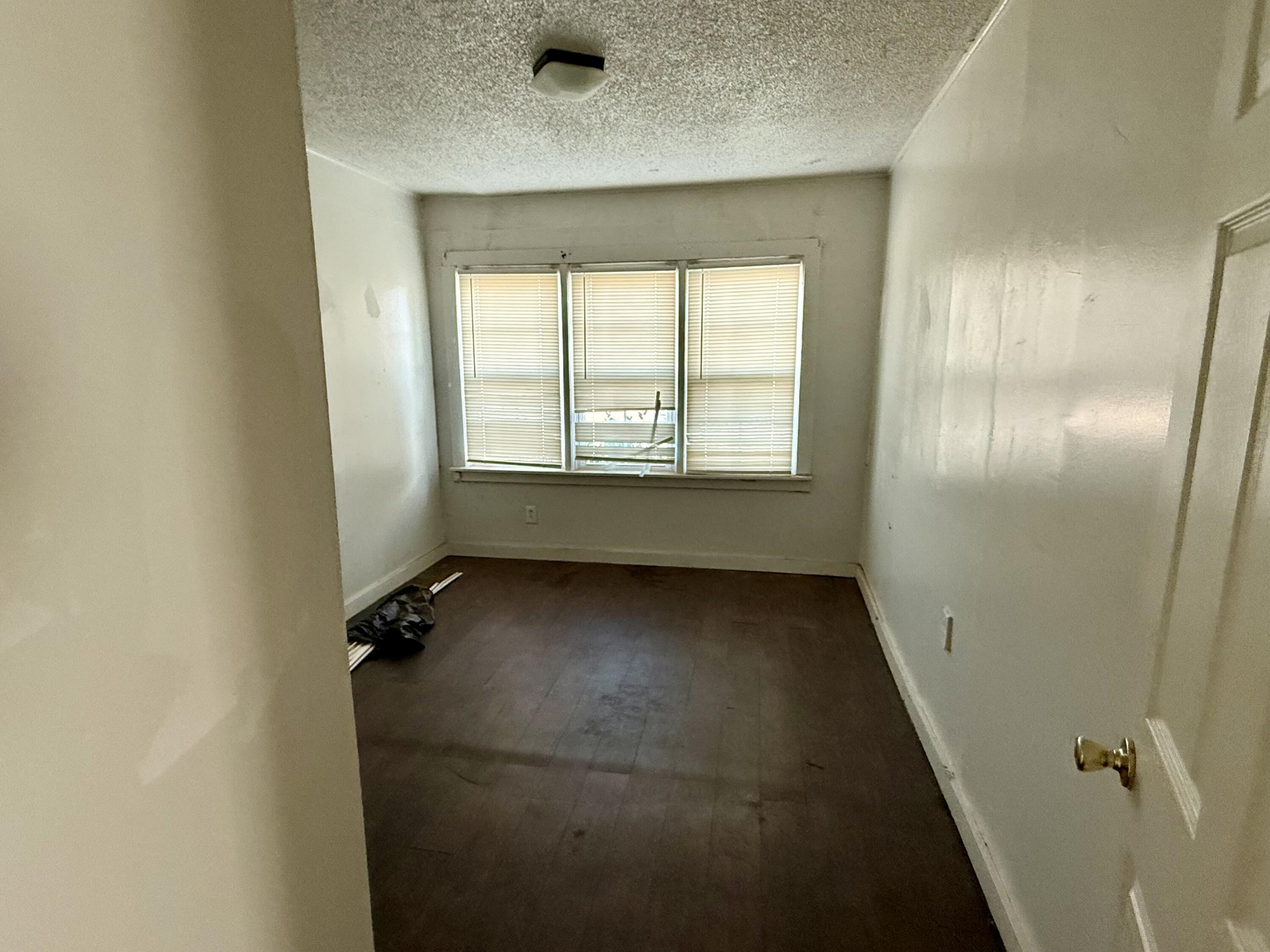 6117 20th Street Lubbock, TX 79407 - Photo 5 of 9 a view of an empty room with a window