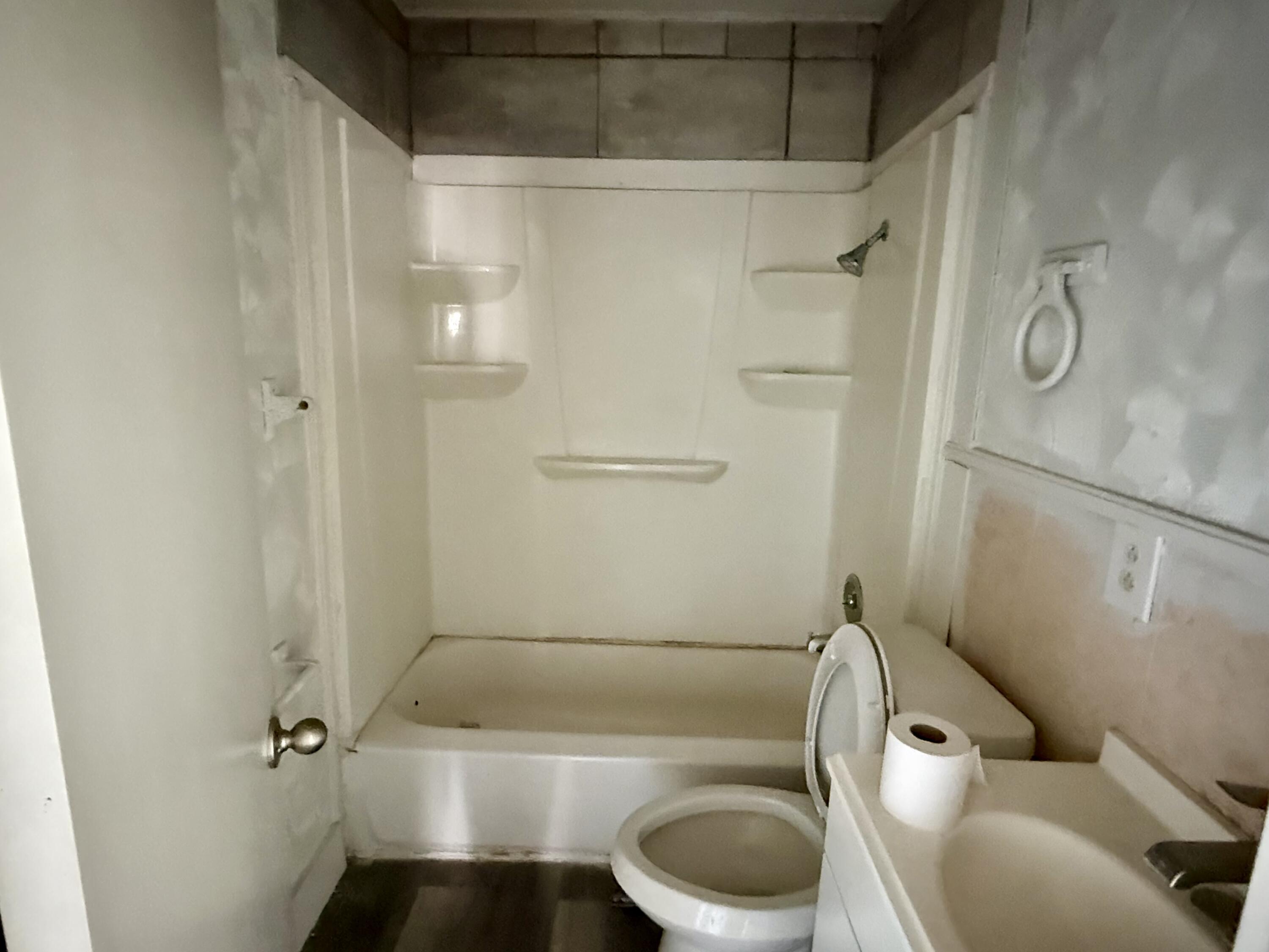 6117 20th Street Lubbock, TX 79407 - Photo 7 of 9 a bathroom with a toilet and a shower