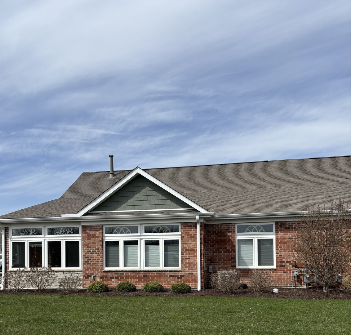 408 Stearn Drive, Unit 408 Genoa, IL 60135 - Photo 1 of 34 front view of a house with a garden