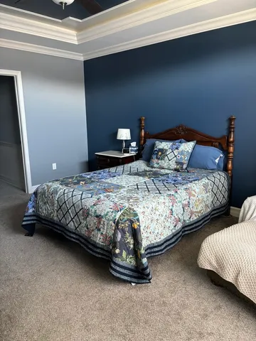 a bedroom with bed and window