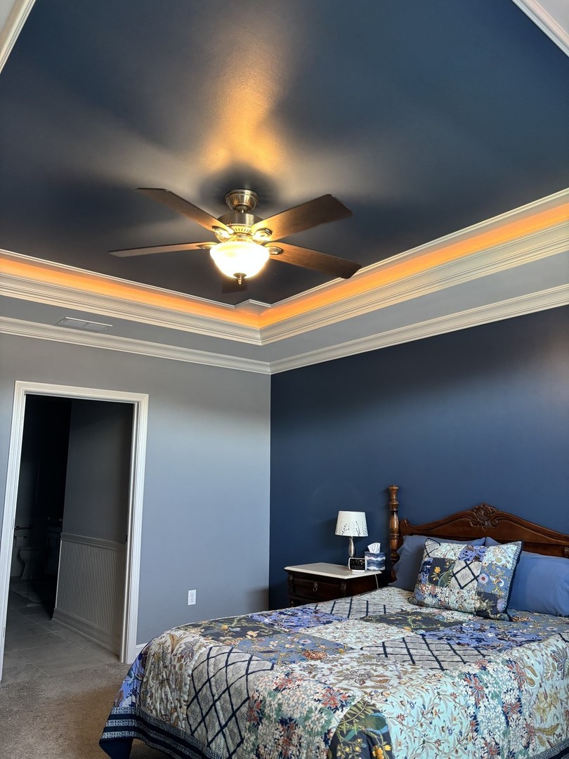 408 Stearn Drive, Unit 408 Genoa, IL 60135 - Photo 13 of 34 a bedroom with a bed and lamp