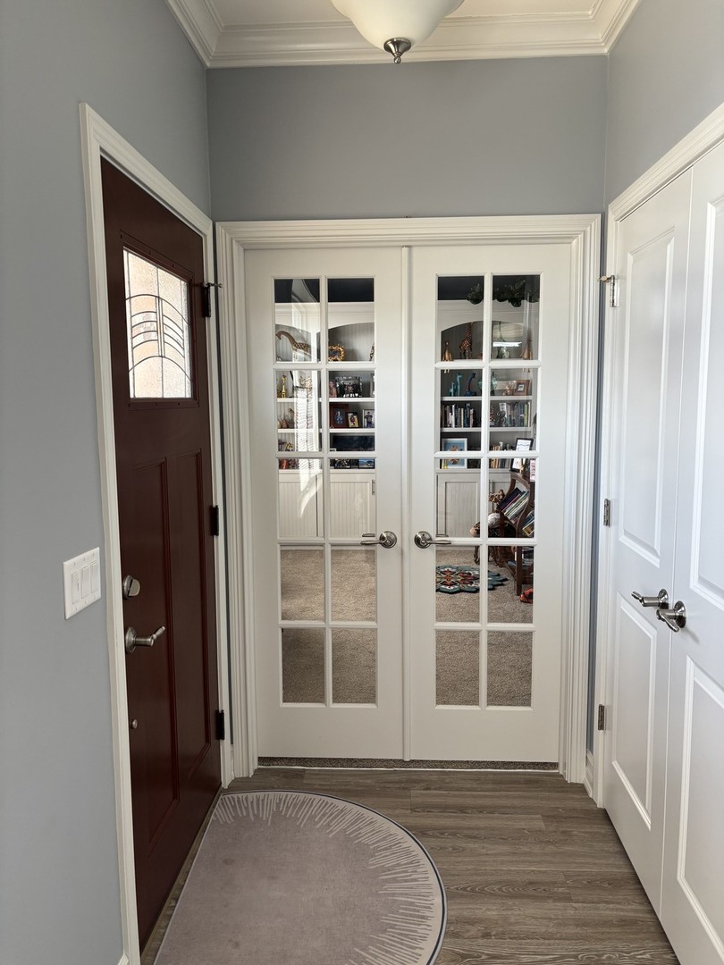 408 Stearn Drive, Unit 408 Genoa, IL 60135 - Photo 19 of 34 an empty room with wooden floor and windows