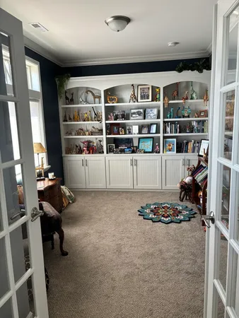 a bedroom with a bed a table and chair