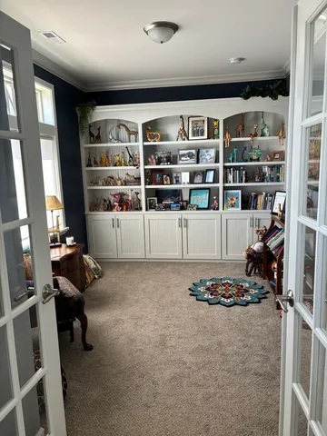 a bedroom with a bed a table and chair