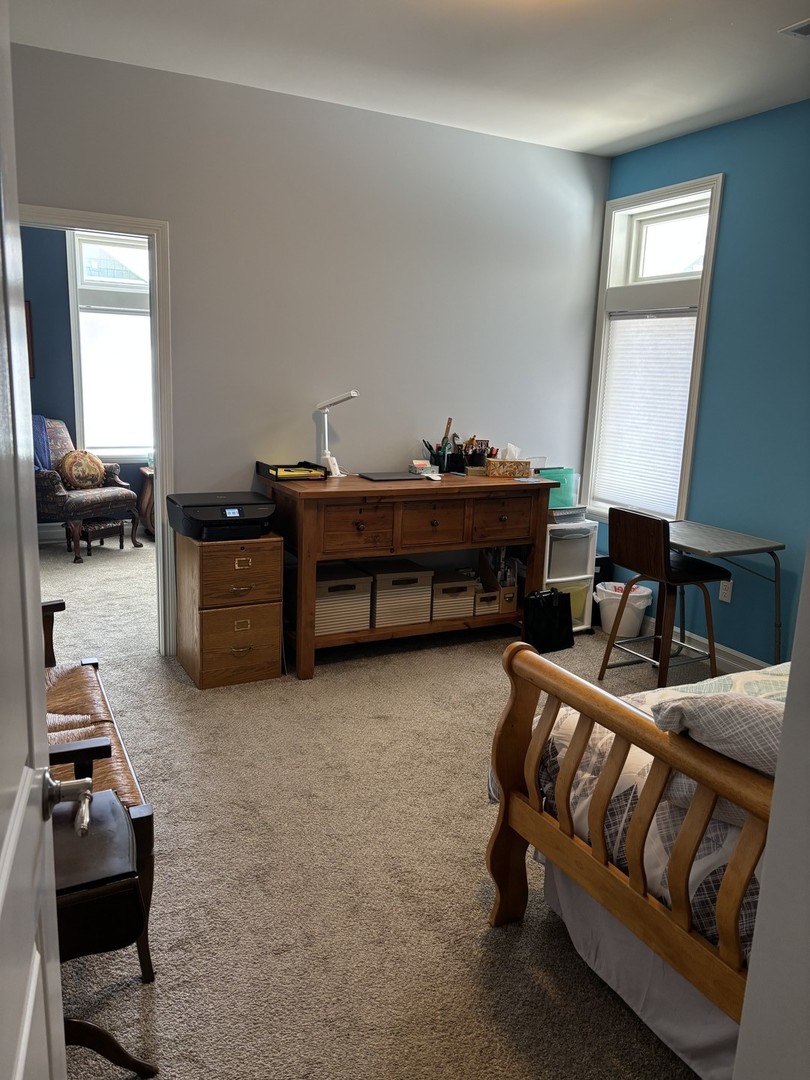 408 Stearn Drive, Unit 408 Genoa, IL 60135 - Photo 22 of 34 a living room with furniture and a window