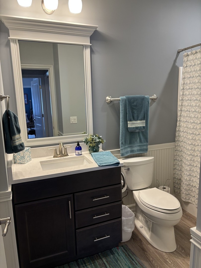 408 Stearn Drive, Unit 408 Genoa, IL 60135 - Photo 23 of 34 a bathroom with a toilet sink and mirror