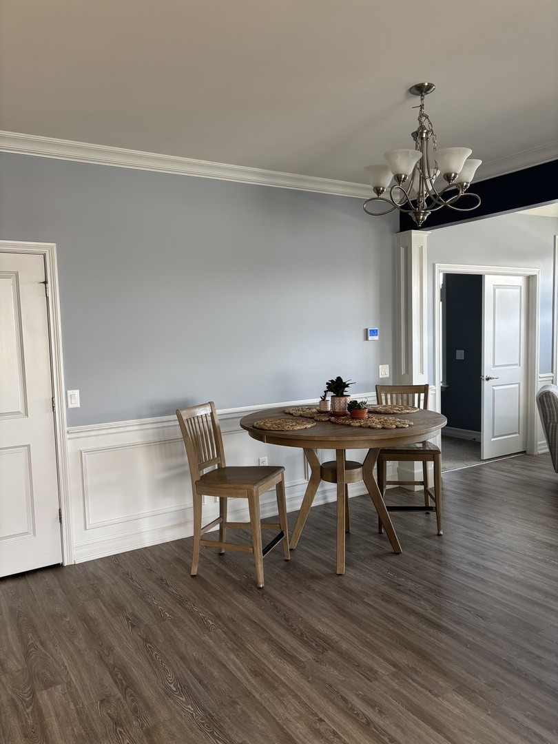 408 Stearn Drive, Unit 408 Genoa, IL 60135 - Photo 4 of 34 a view of a dining room with furniture and wooden floor