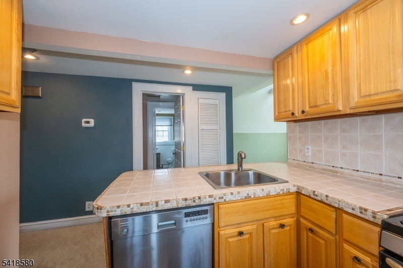 41 Beekman Street, Unit 3 Bloomfield, NJ 07003 - Photo 3 of 12 a kitchen with a sink and cabinets