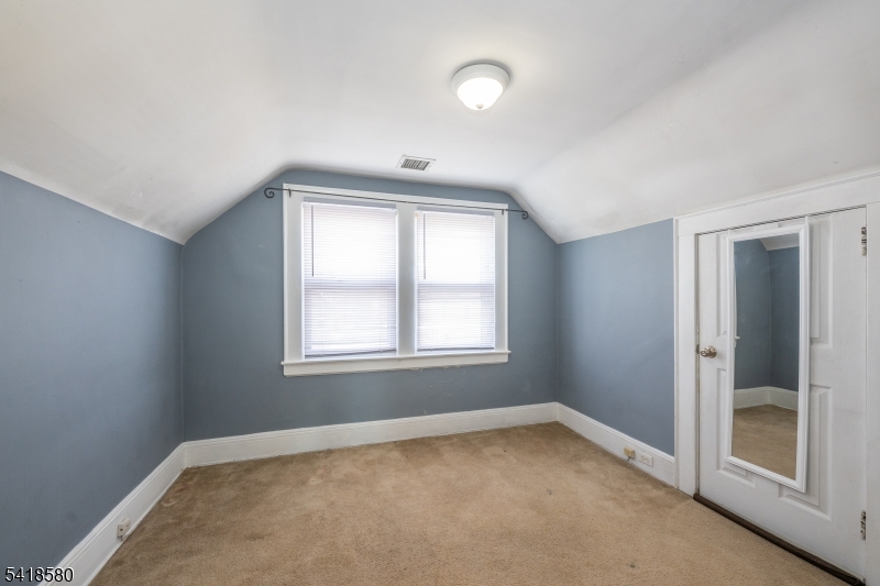 41 Beekman Street, Unit 3 Bloomfield, NJ 07003 - Photo 6 of 12 an empty room with windows