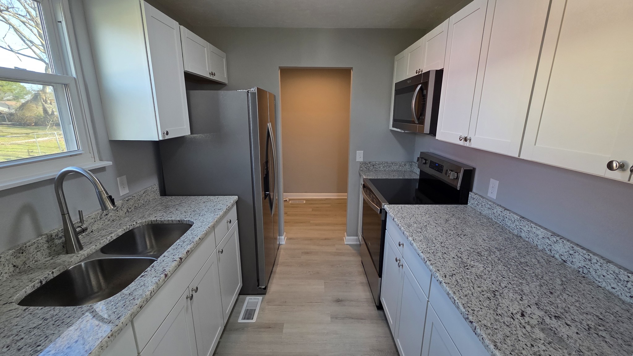 6414 Amanda Way Murfreesboro, TN 37129 - Photo 3 of 13 a kitchen with stainless steel appliances granite countertop a sink stove and refrigerator