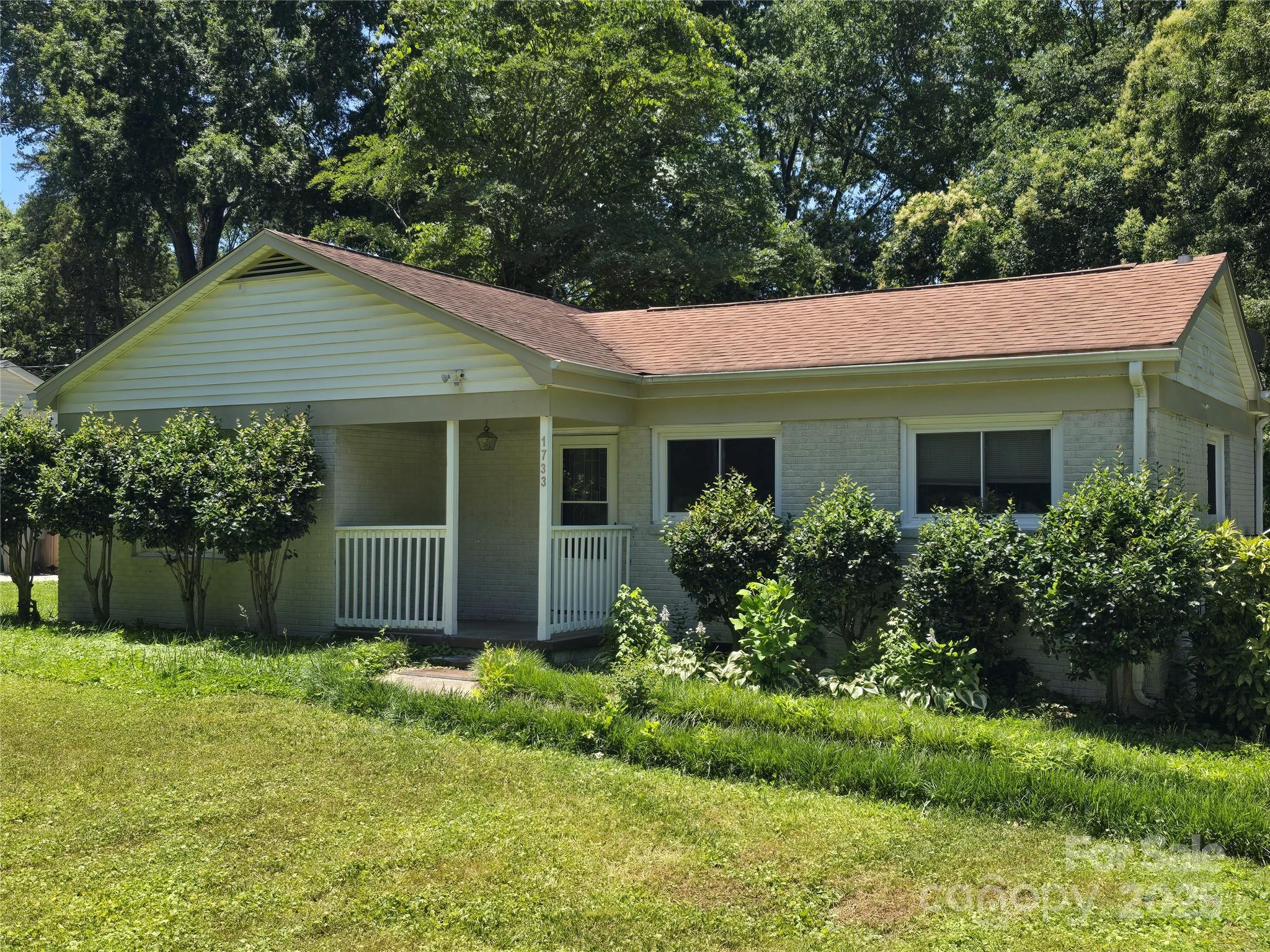 a front view of house with yard and green space