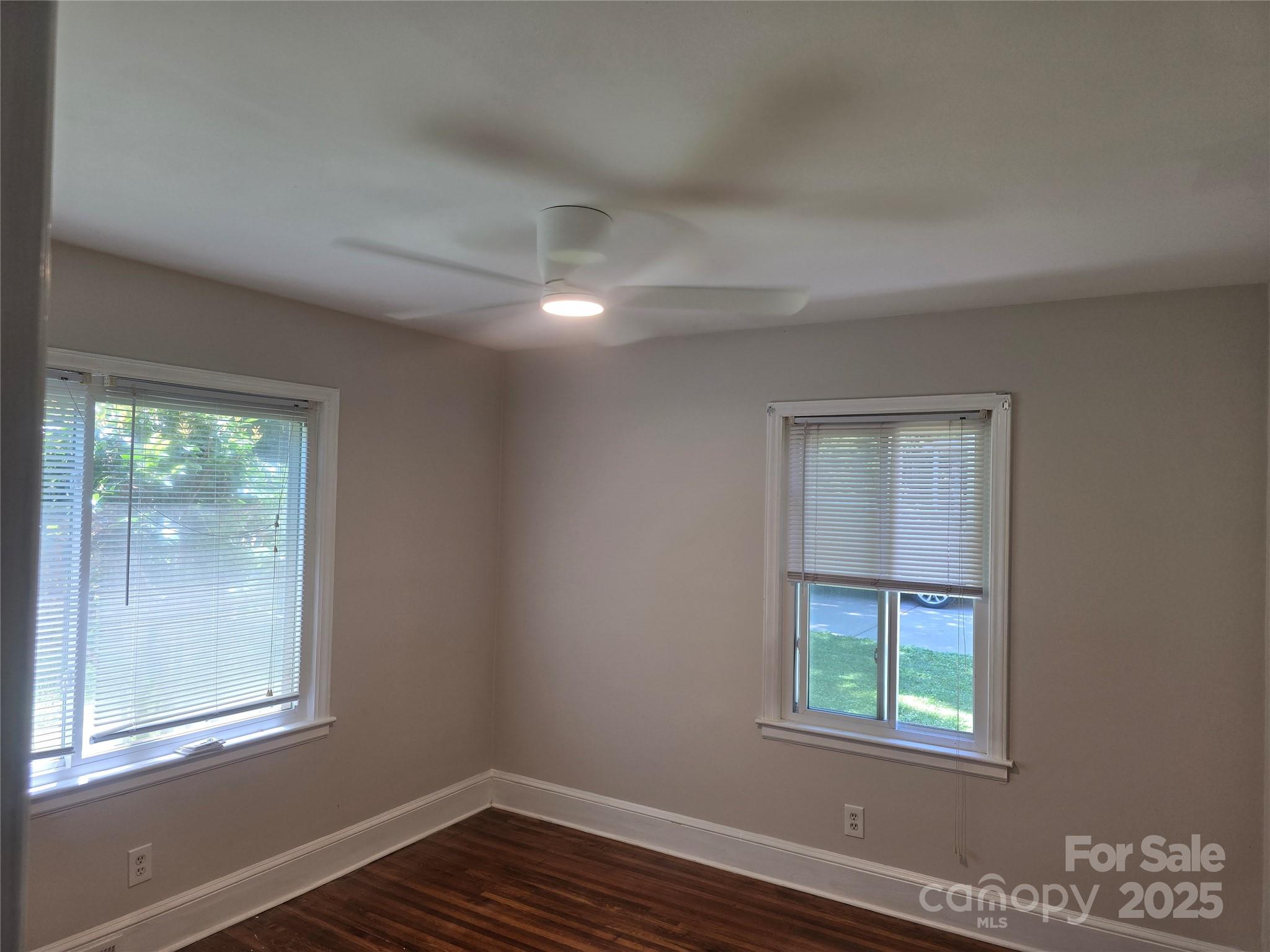 1733 Merry Oaks Road Charlotte, NC 28205 - Photo 4 of 11 an empty room with wooden floor and windows