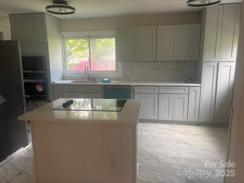 1733 Merry Oaks Road Charlotte, NC 28205 - Photo 6 of 11 a kitchen with kitchen island a counter space a sink a window and stainless steel appliances