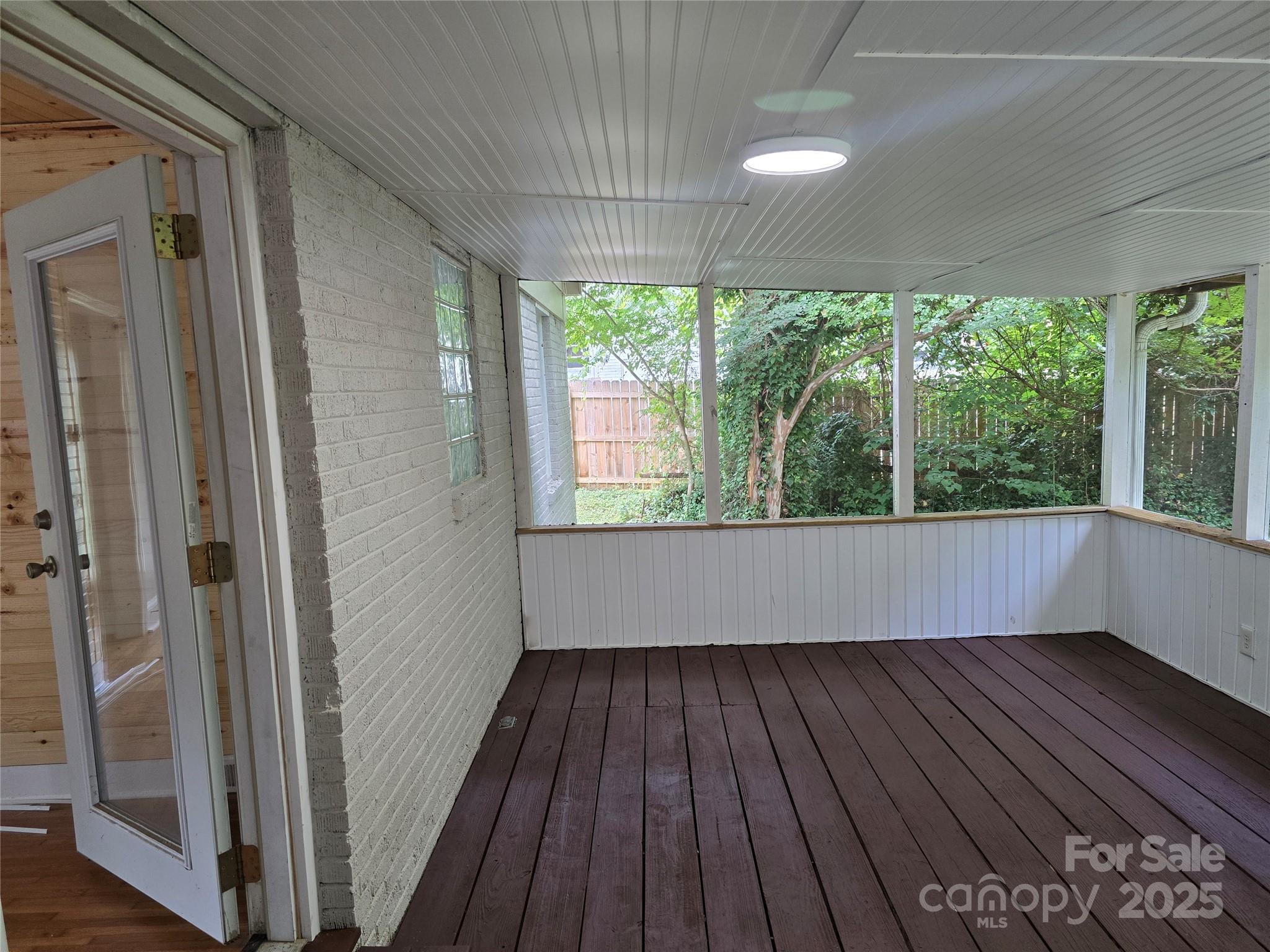 1733 Merry Oaks Road Charlotte, NC 28205 - Photo 9 of 11 a view of hallway with a large window and wooden floor