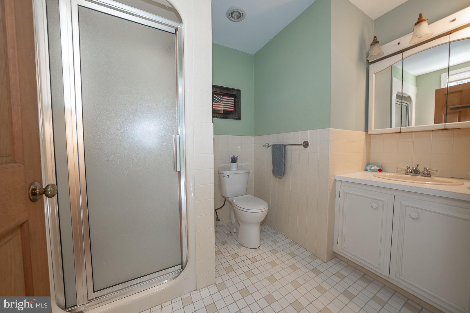 395 Bair Road Berwyn, PA 19312 - Photo 43 of 51 a spacious bathroom with a toilet sink and a mirror