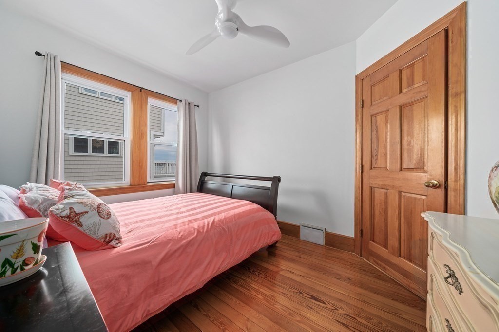 121 Edgewater Road Hull, MA 02045 - Photo 12 of 42 a bedroom with a bed and wooden floor
