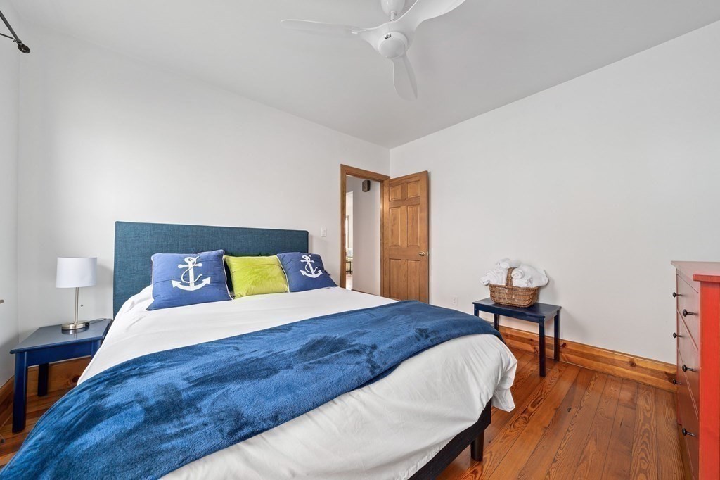 121 Edgewater Road Hull, MA 02045 - Photo 14 of 42 a bedroom with a bed and a table in it