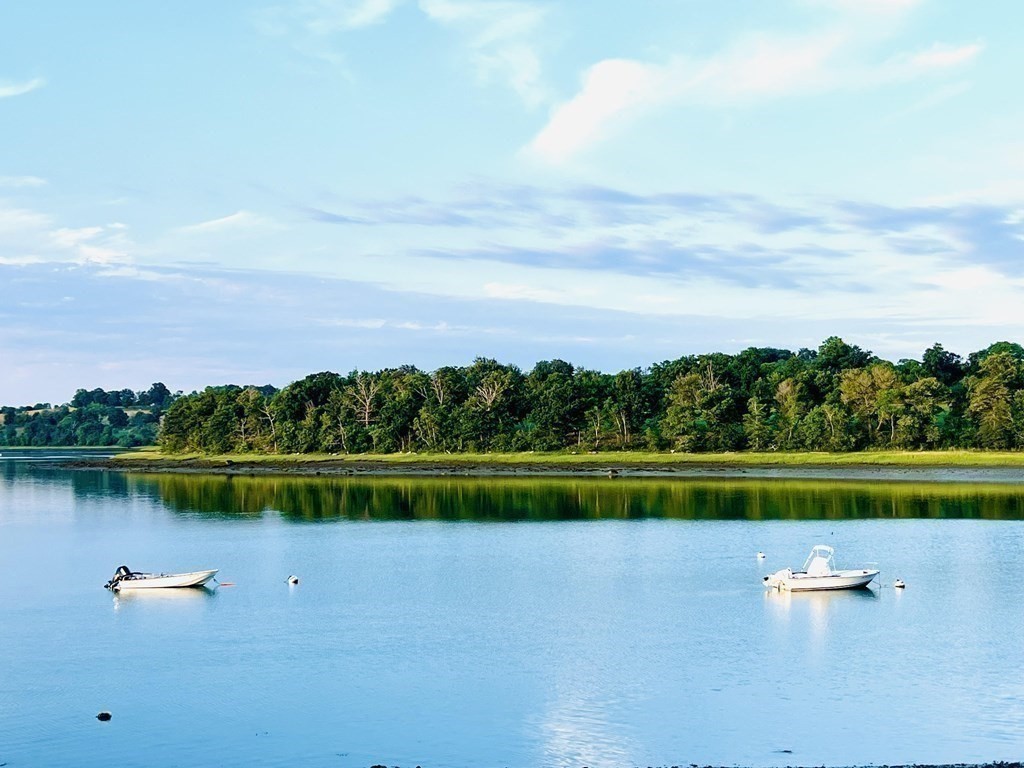 121 Edgewater Road Hull, MA 02045 - Photo 2 of 42 a view of a lake with houses in the back