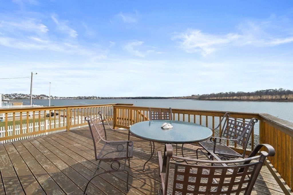 121 Edgewater Road Hull, MA 02045 - Photo 21 of 42 a balcony with a table and chairs