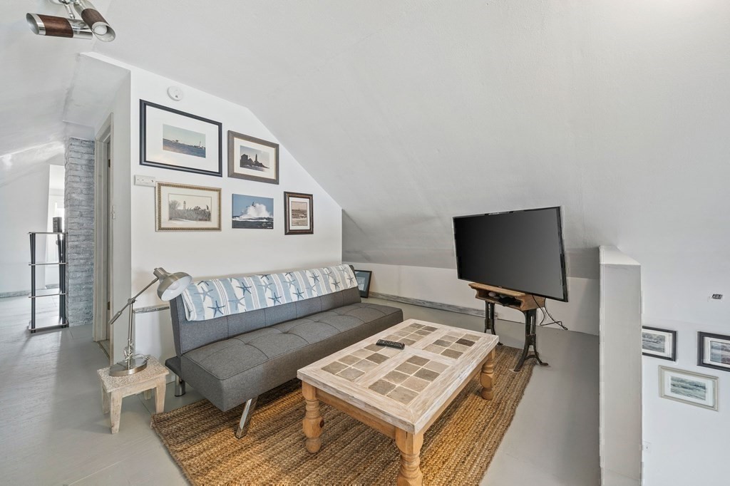 121 Edgewater Road Hull, MA 02045 - Photo 23 of 42 a view of a workspace with furniture and a window