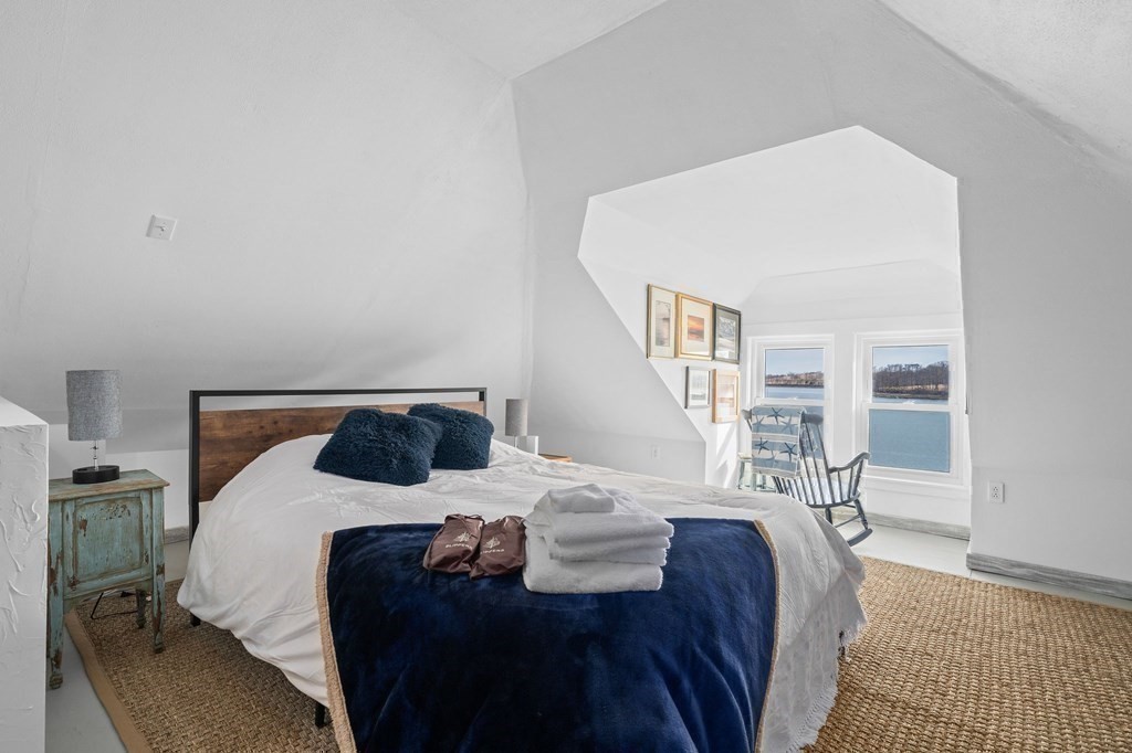 121 Edgewater Road Hull, MA 02045 - Photo 24 of 42 a bedroom with a bed and wooden floor