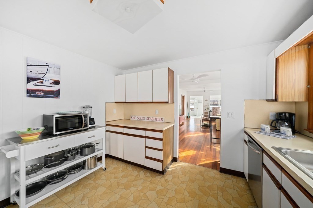 121 Edgewater Road Hull, MA 02045 - Photo 5 of 42 a kitchen with stainless steel appliances a stove a sink and a refrigerator