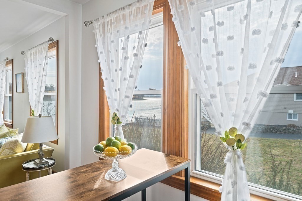 121 Edgewater Road Hull, MA 02045 - Photo 7 of 42 a living room with furniture and a table