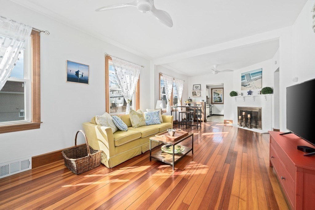 121 Edgewater Road Hull, MA 02045 - Photo 10 of 42 a living room with furniture and a fireplace