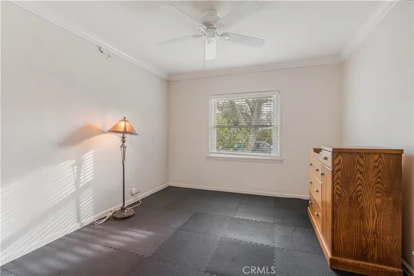 an empty room with windows and cabinet