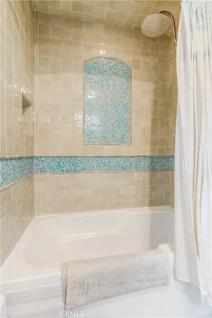 a bathroom with a granite countertop bathtub and shower