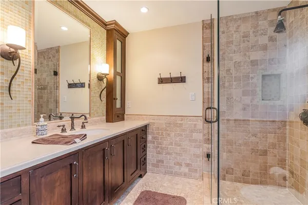 a bathroom with a double vanity sink mirror and shower