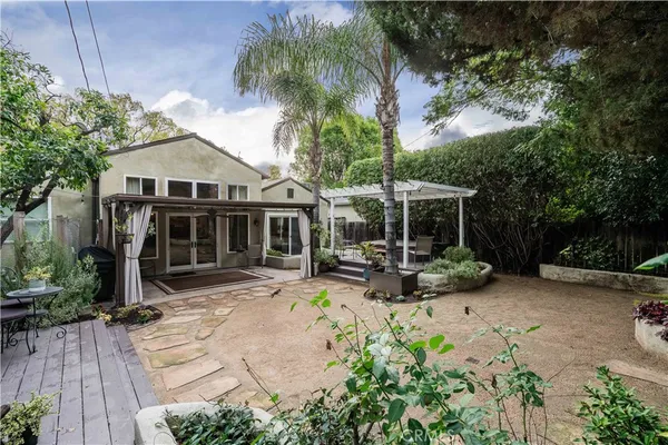 a view of a house with sitting area and garden