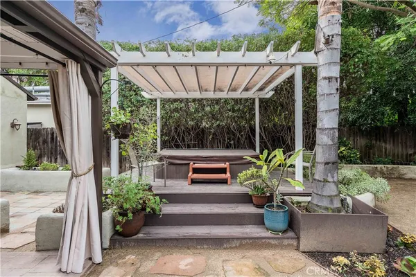 a view of a patio with couches and potted plants